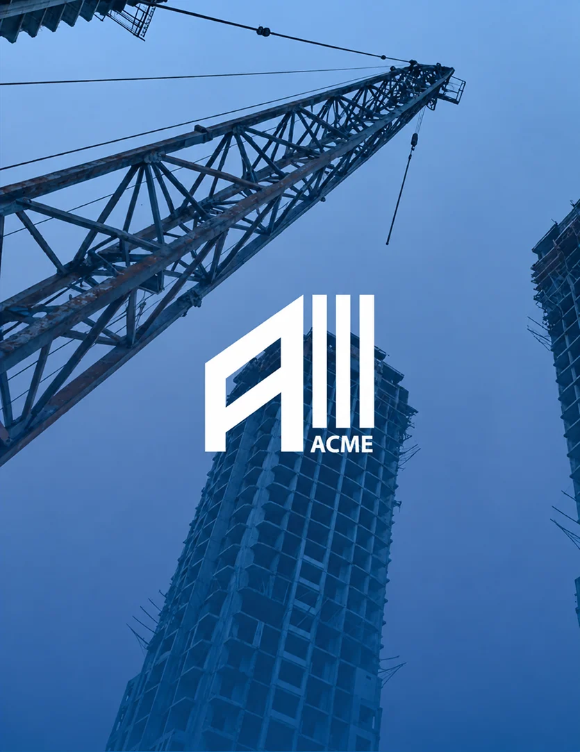 The ACME mark over a tower crane and a high-rise under construction, washed in blue