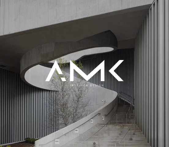 The AMK mark over a concrete spiral stair