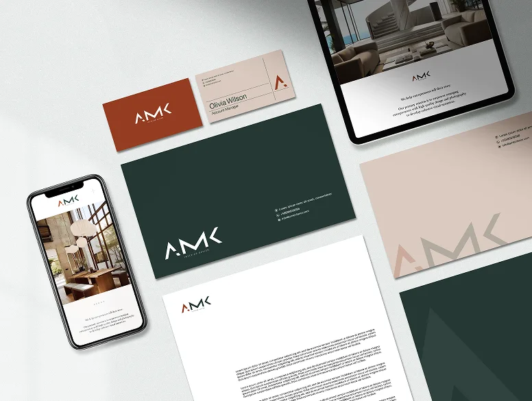 The AMK stationery set: business cards, envelopes, a letterhead, a phone and a tablet