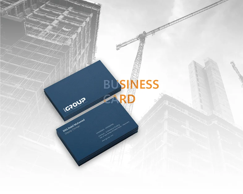 iGroup Construction business cards in navy against a construction site