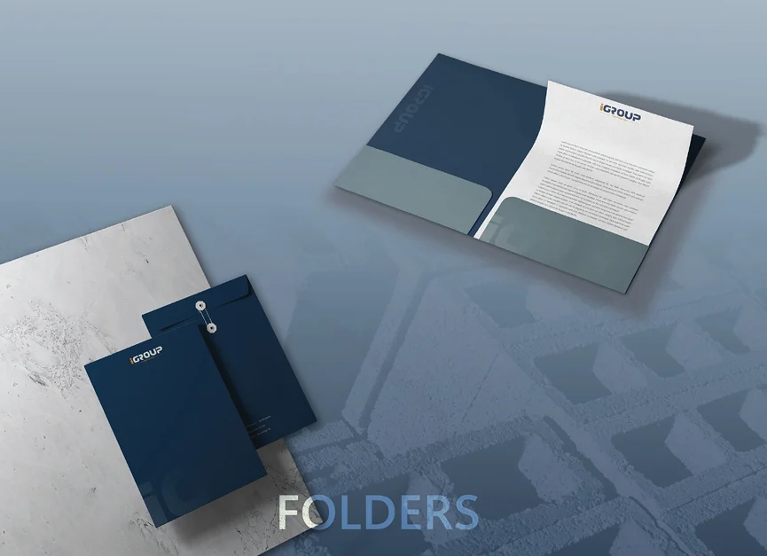iGroup Construction folders in navy, one open on a letterhead