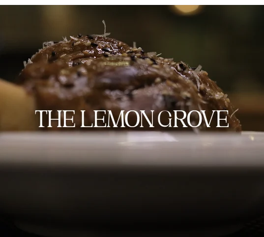 The Lemon Grove wordmark over a chocolate dessert