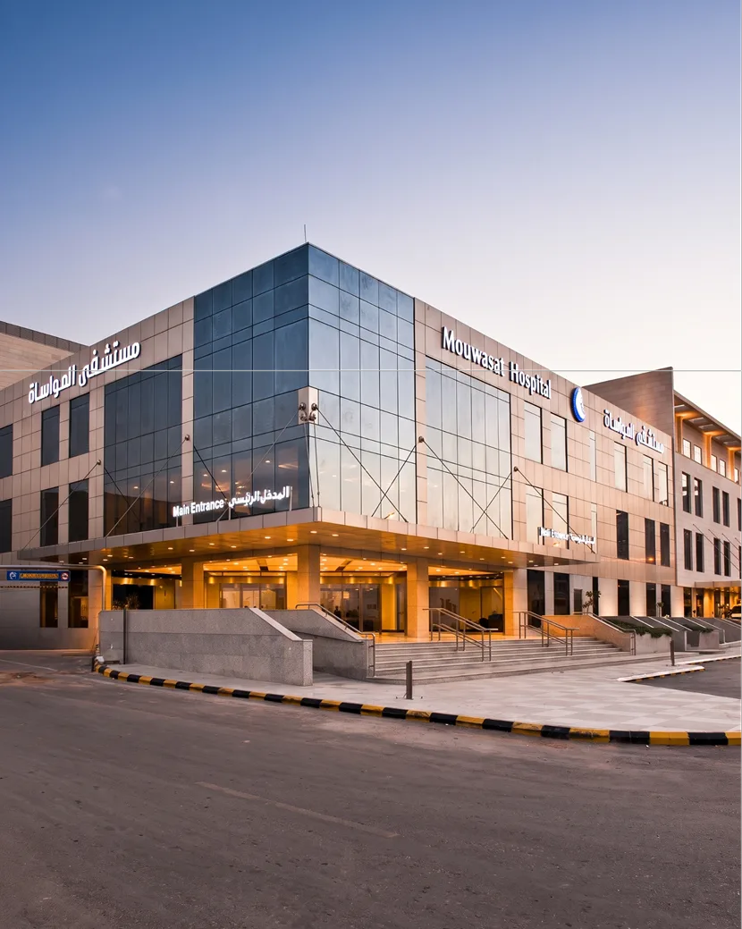 Mouwasat Hospital's main entrance at dusk, one of Lujain Group's projects